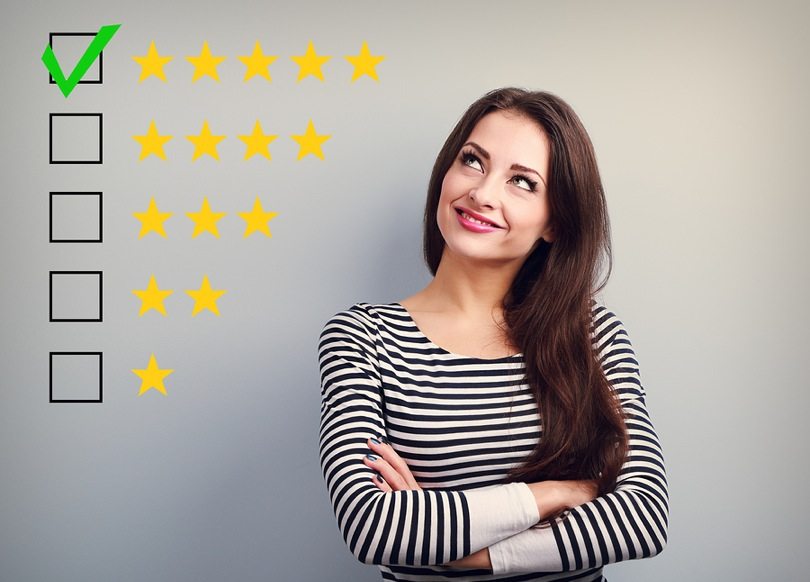 woman standing next to 5 star reviews
